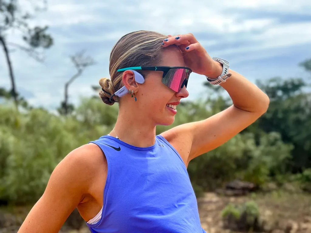 Issy Hayes training outdoors wearing Ampact Sprinter 100 Mini bone conduction headphones